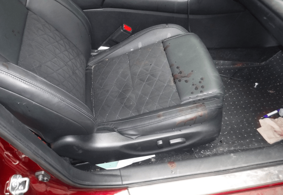 Black leather seat in a car with stain after Dead Body Cleanup Services in Dallas, Denton, Fort Worth, Irving, McKinney, Plano