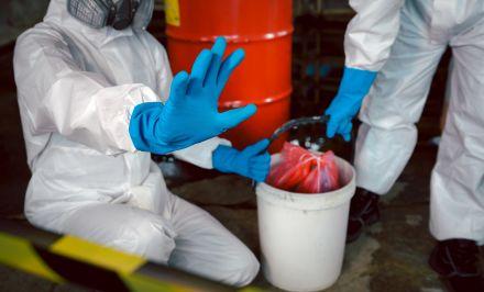 Biohazard cleanup technician disinfecting a surface in Dallas County