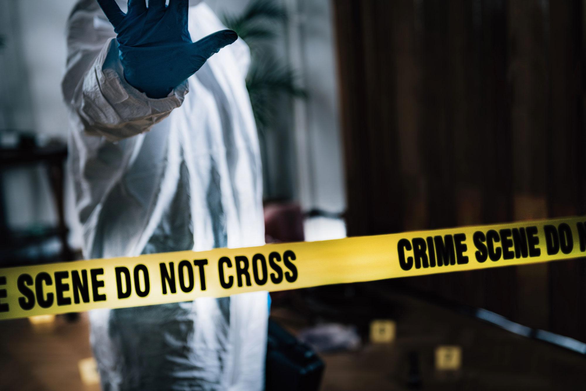 Crime scene cleanup technician disinfecting a surface in Dallas